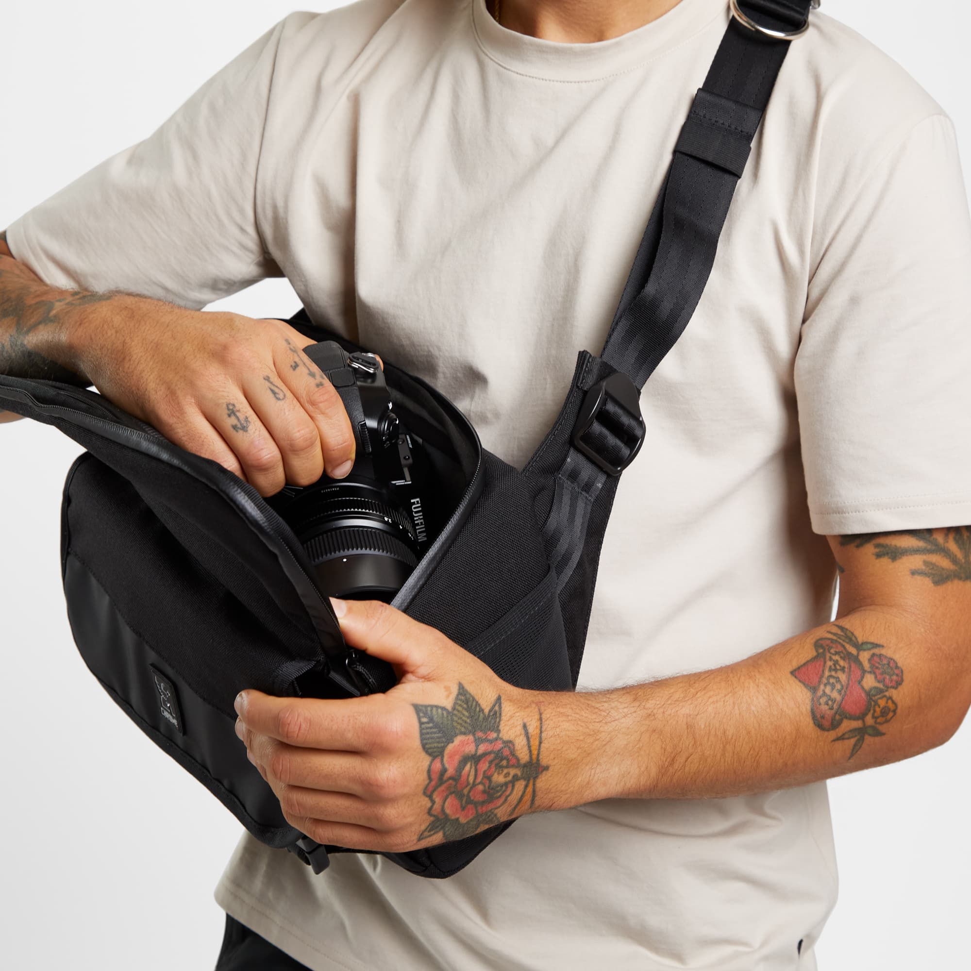 Niko tech camera sling in black person showing top opening