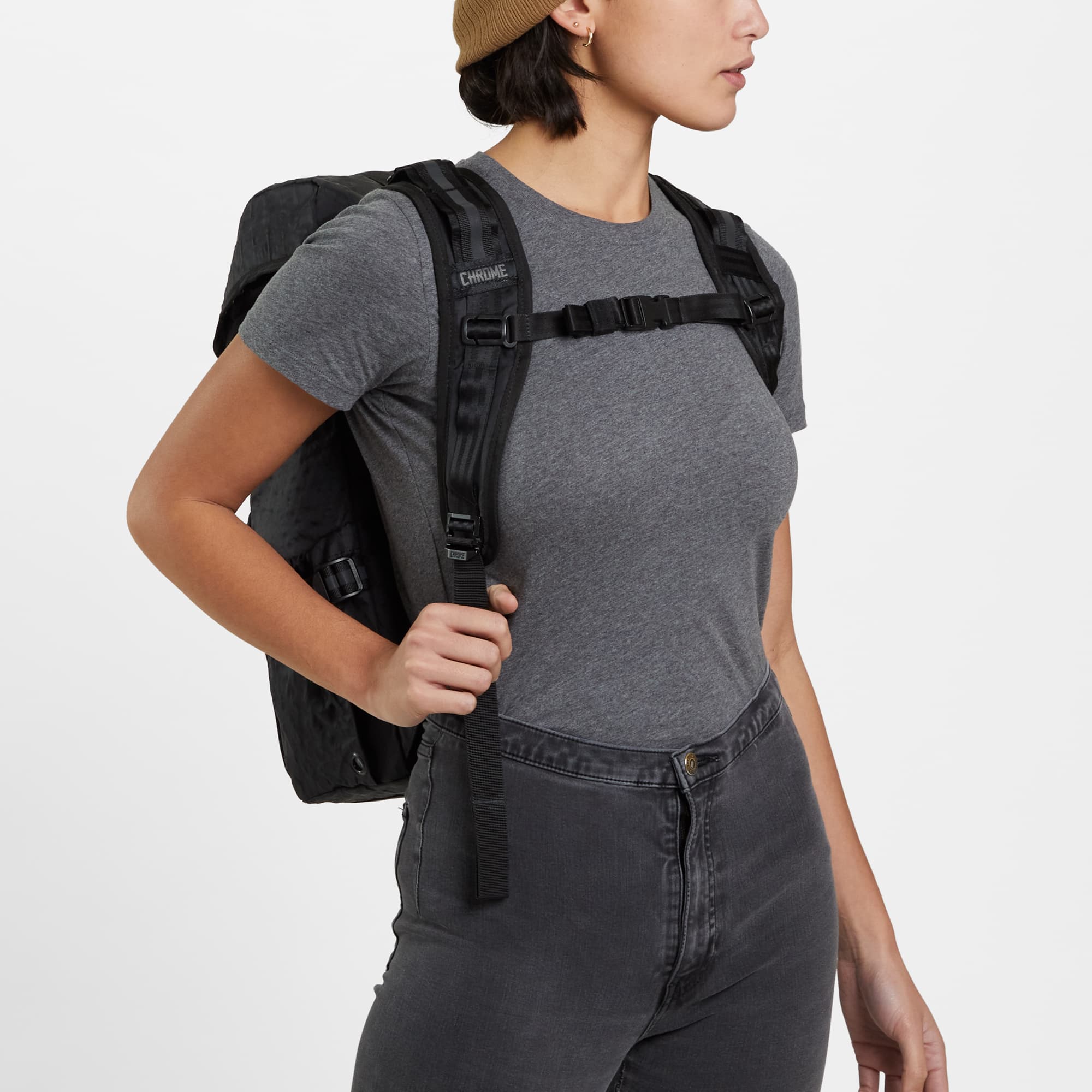 Tensile Ruckpack in black worn by a woman front view #color_black