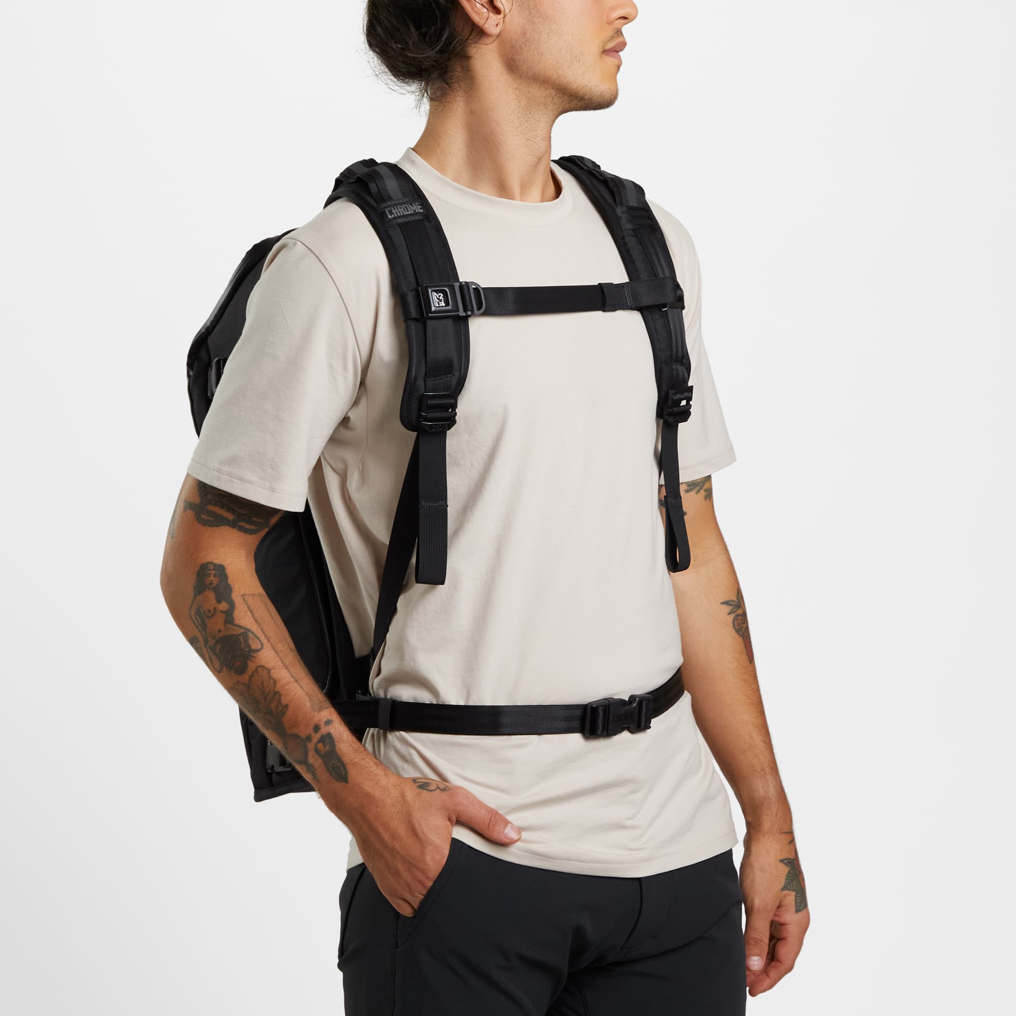 Niko camera tech backpack in black worn by a man
