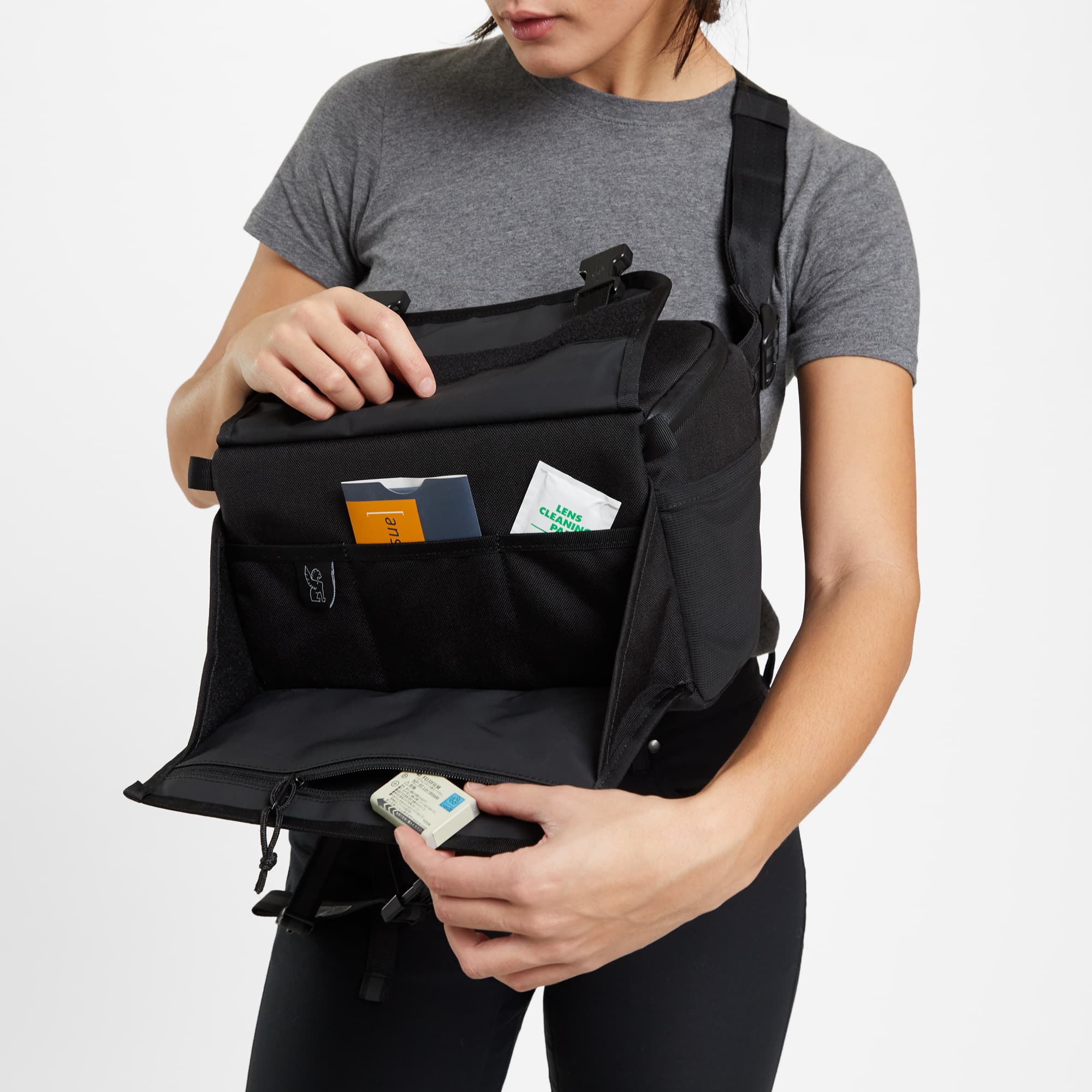 Niko tech camera sling in black a woman is utilizing the bag
