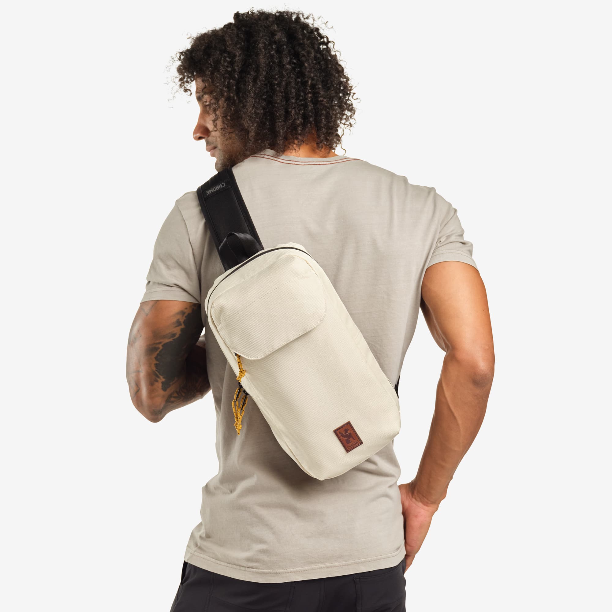 Ruckas Sling in natural worn by a man #color_natural