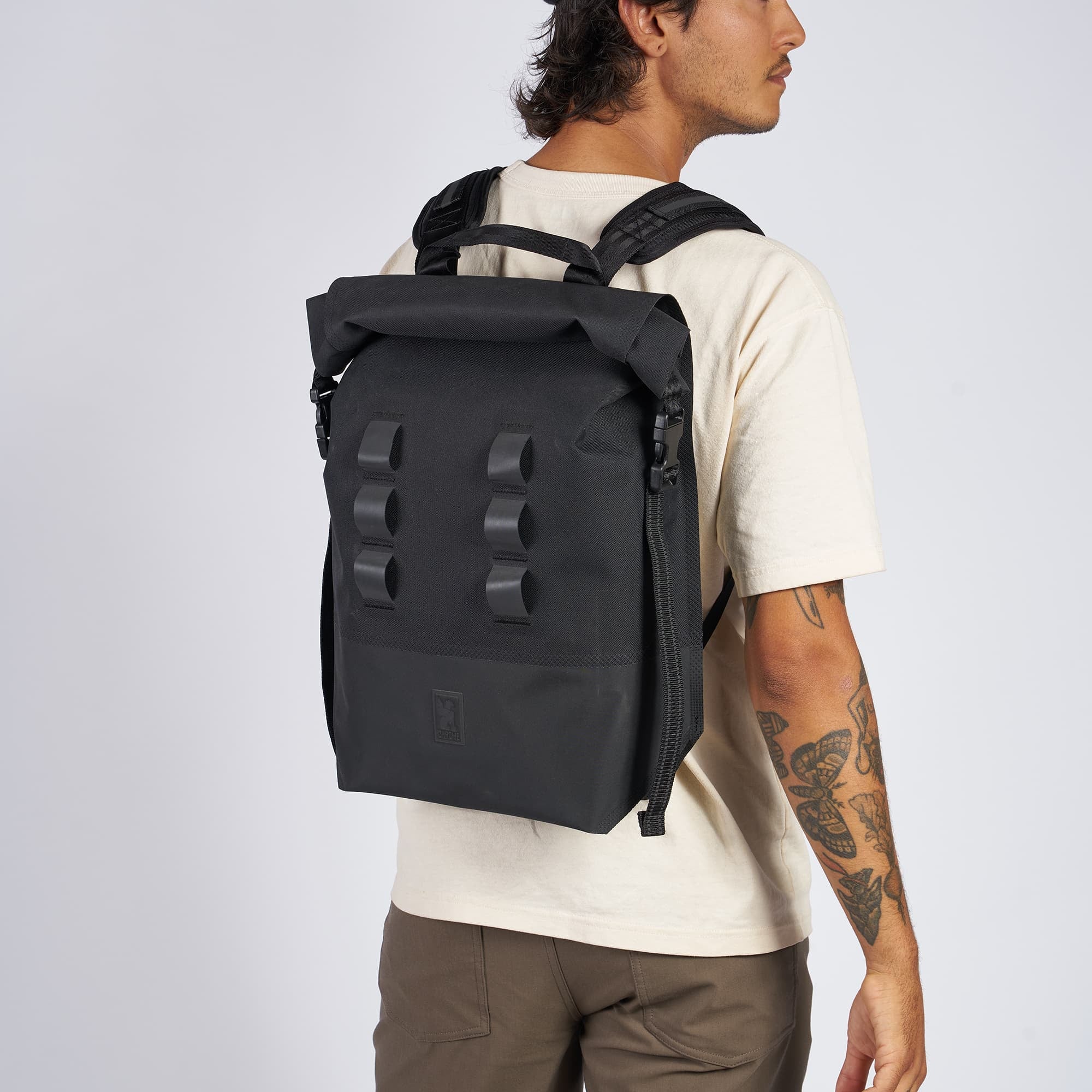 Waterproof 20L backpack in black worn by a man #color_black