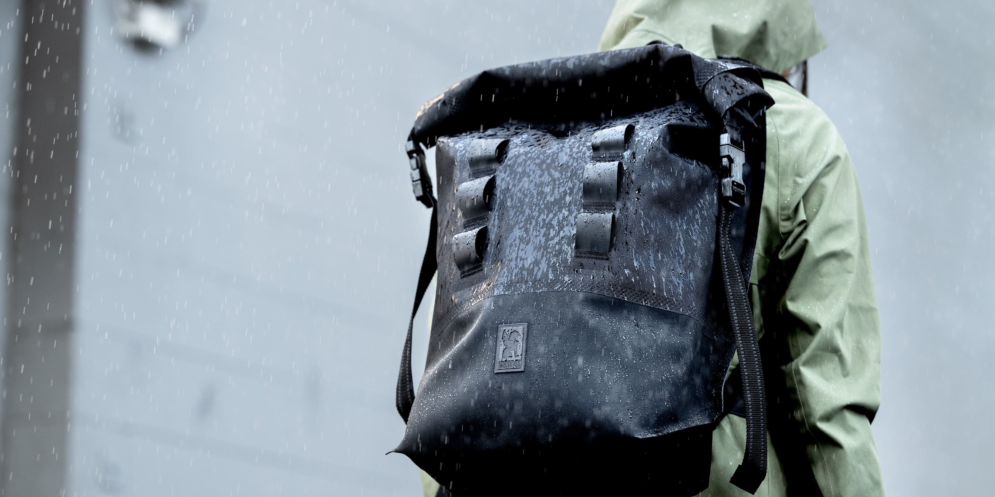 Urban Ex 20L Backpack worn by a person in the rain desktop image size
